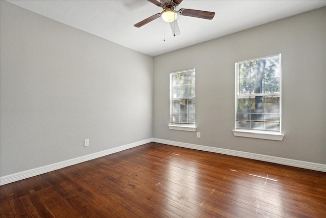 spare room with ceiling fan, hardwood / wood-style floors, and baseboards