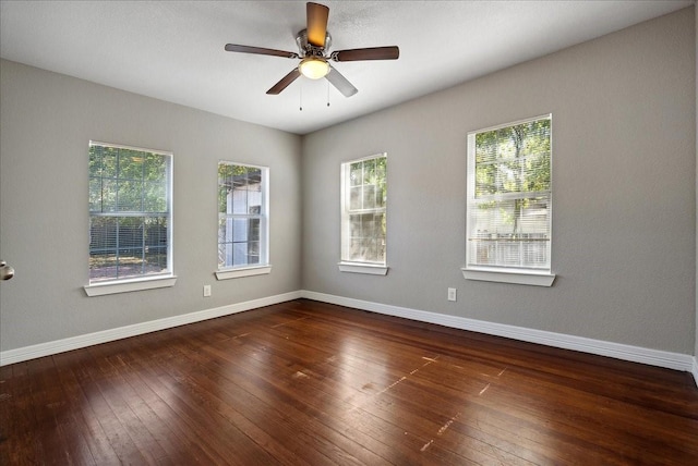 empty room featuring a ceiling fan, wood-type flooring, and baseboards