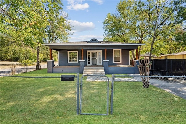 view of front of property featuring a front yard, a fenced front yard, covered porch, and a gate