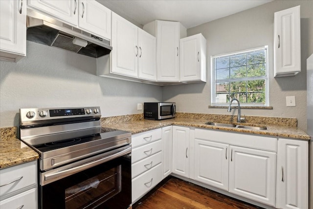 kitchen featuring white cabinetry, a sink, appliances with stainless steel finishes, under cabinet range hood, and dark wood-type flooring