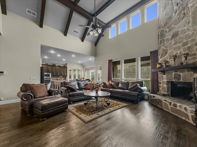 living room featuring visible vents, a ceiling fan, a healthy amount of sunlight, and high vaulted ceiling