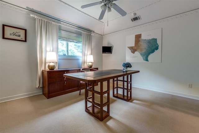 home office featuring baseboards, ceiling fan, light carpet, and visible vents