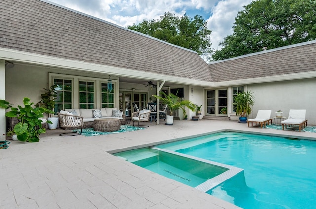 view of swimming pool featuring a pool with connected hot tub, ceiling fan, an outdoor living space, french doors, and a patio
