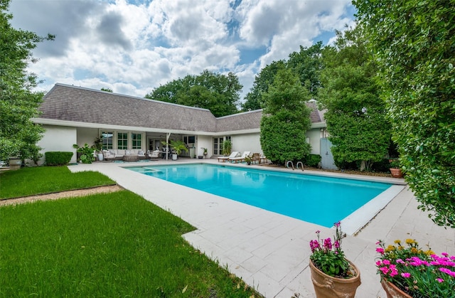 pool featuring a patio and a yard
