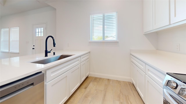 338 S 3rd St, Jacksboro, TX 76458 - kitchen with white cabinetry, a sink, appliances with stainless steel finishes, and light countertops