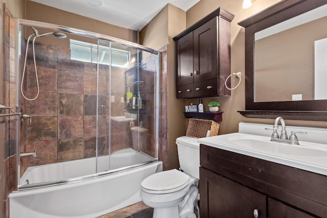 full bathroom featuring enclosed tub / shower combo, toilet, and vanity