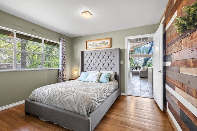 bedroom featuring visible vents, wood finished floors, and baseboards