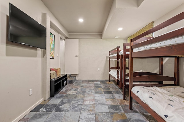 unfurnished bedroom featuring recessed lighting and stone finish floor