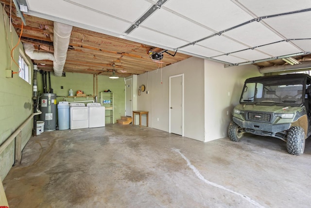 garage featuring washing machine and dryer, water heater, and a garage door opener