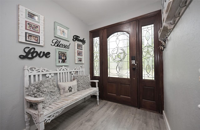 entrance foyer featuring light wood finished floors and baseboards