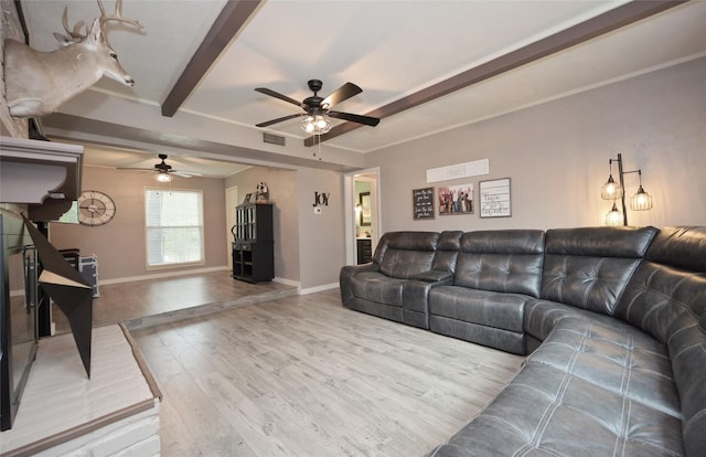 living room featuring beamed ceiling, a ceiling fan, visible vents, baseboards, and wood finished floors