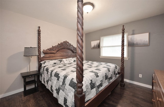 bedroom with wood finished floors and baseboards