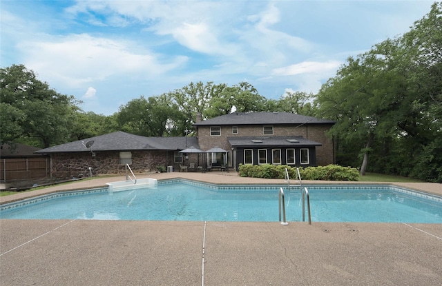 pool featuring a patio and fence