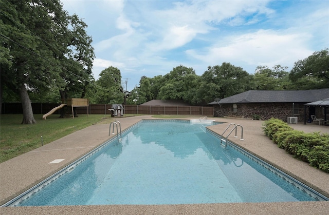 view of pool featuring a fenced backyard, a yard, a fenced in pool, a patio area, and a playground