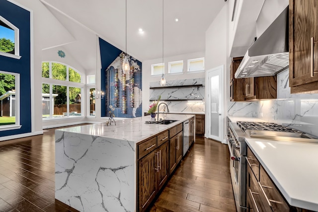 509 Basilica Ln, Mckinney, TX 75071 - kitchen featuring appliances with stainless steel finishes, wall chimney range hood, a sink, dark wood-style flooring, and high vaulted ceiling
