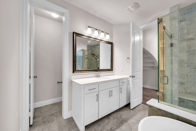509 Basilica Ln, Mckinney, TX 75071 - bathroom with marble finish floors, a shower stall, vanity, baseboards, and a freestanding tub