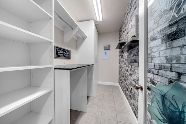 509 Basilica Ln, Mckinney, TX 75071 - walk in closet with light tile patterned flooring