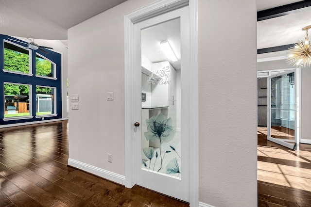 509 Basilica Ln, Mckinney, TX 75071 - hall featuring baseboards, hardwood / wood-style floors, a chandelier, and a textured wall