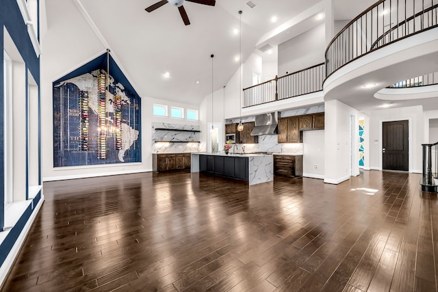 509 Basilica Ln, Mckinney, TX 75071 - unfurnished living room with high vaulted ceiling, a ceiling fan, dark wood finished floors, a sink, and baseboards