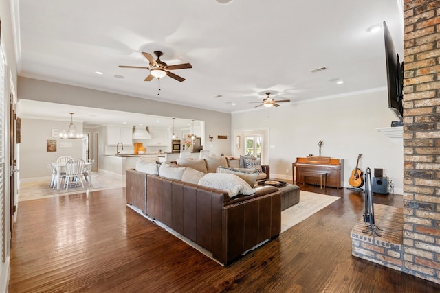 living room featuring recessed lighting, baseboards, dark wood finished floors, and ceiling fan with notable chandelier
