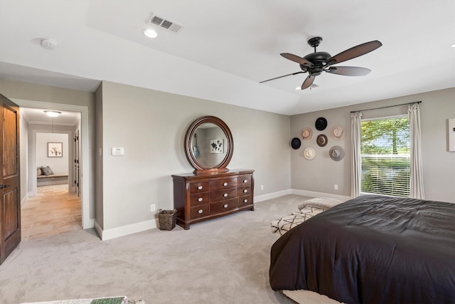 bedroom featuring baseboards, visible vents, attic access, and light colored carpet