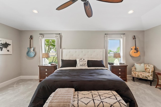 bedroom featuring ceiling fan, light carpet, and baseboards