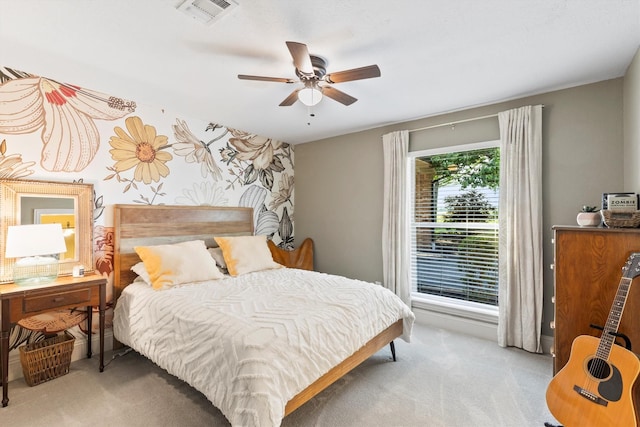 bedroom featuring visible vents, ceiling fan, and light carpet