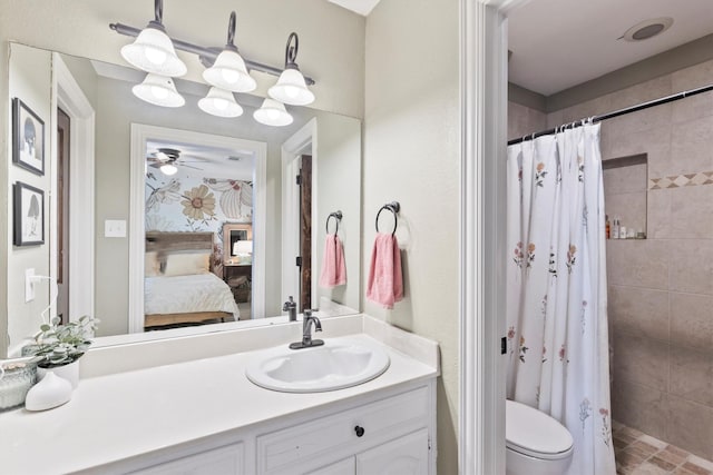 ensuite bathroom featuring ceiling fan, toilet, vanity, ensuite bath, and tiled shower