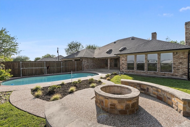 view of swimming pool featuring a fire pit, a fenced backyard, a patio, and a fenced in pool