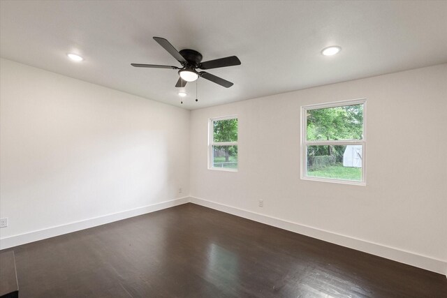 unfurnished room with baseboards, recessed lighting, and dark wood-style floors
