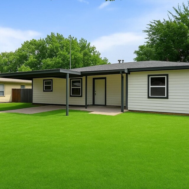back of house featuring a lawn, a patio area, and fence