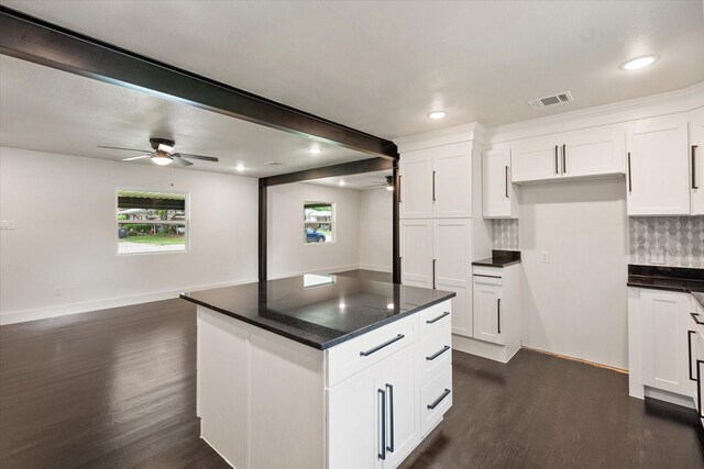 kitchen with visible vents, ceiling fan, dark wood-style floors, and beamed ceiling