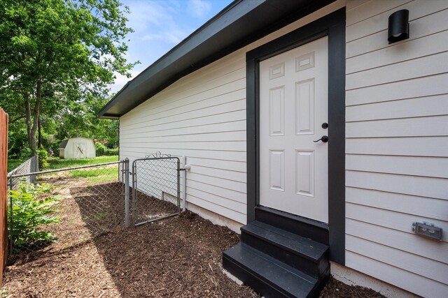 doorway to property featuring fence