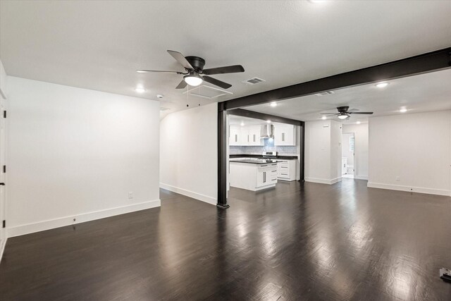 unfurnished living room with visible vents, a ceiling fan, and baseboards
