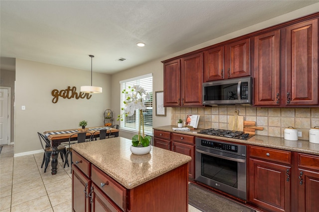kitchen with reddish brown cabinets, visible vents, appliances with stainless steel finishes, and decorative backsplash