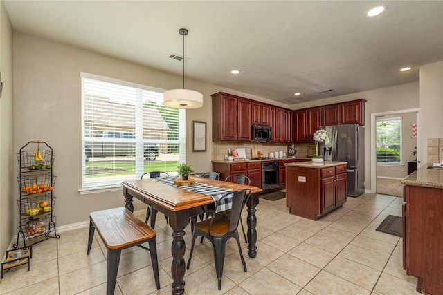 dining space with baseboards, visible vents, and light tile patterned floors