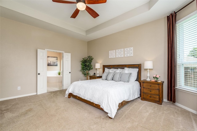 carpeted bedroom featuring baseboards, ceiling fan, connected bathroom, and multiple windows