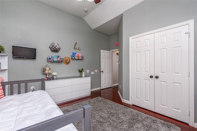 bedroom featuring a closet, vaulted ceiling, ceiling fan, dark wood-style flooring, and baseboards