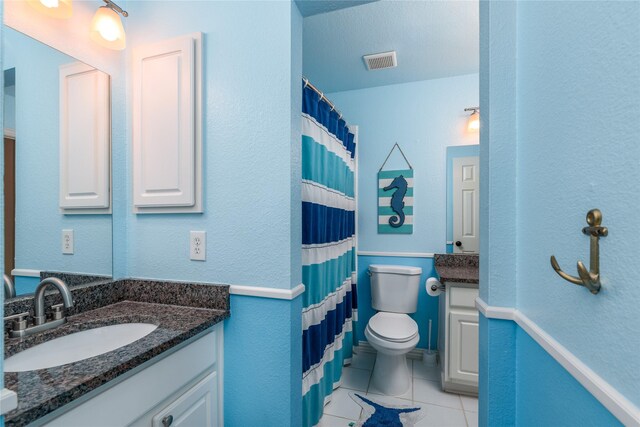 full bathroom with toilet, tile patterned flooring, visible vents, and vanity