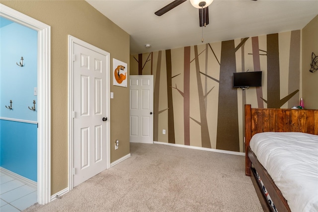 carpeted bedroom with ceiling fan and baseboards