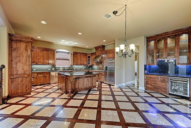 kitchen with beverage cooler, visible vents, stainless steel appliances, a center island, and under cabinet range hood