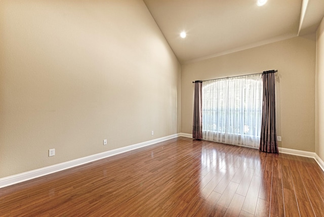 spare room with recessed lighting, high vaulted ceiling, dark wood-style floors, and baseboards