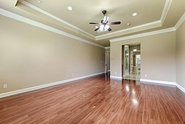 spare room with ornamental molding, ceiling fan, and a tray ceiling