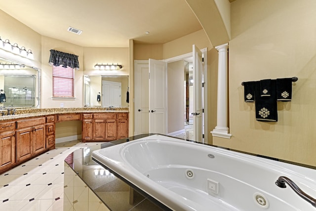 full bathroom featuring double vanity, visible vents, a whirlpool tub, decorative columns, and tile patterned floors