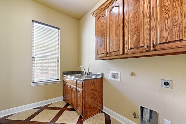 laundry area featuring hookup for an electric dryer, a sink, hookup for a gas dryer, washer hookup, and baseboards