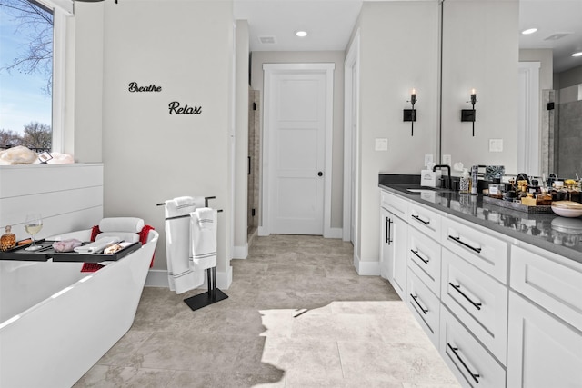 full bath with a freestanding tub, recessed lighting, a shower stall, and vanity
