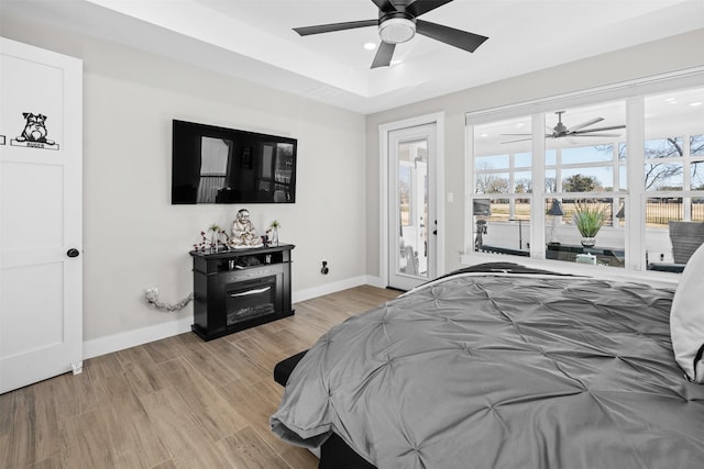 bedroom featuring ceiling fan, baseboards, recessed lighting, wood finished floors, and access to outside