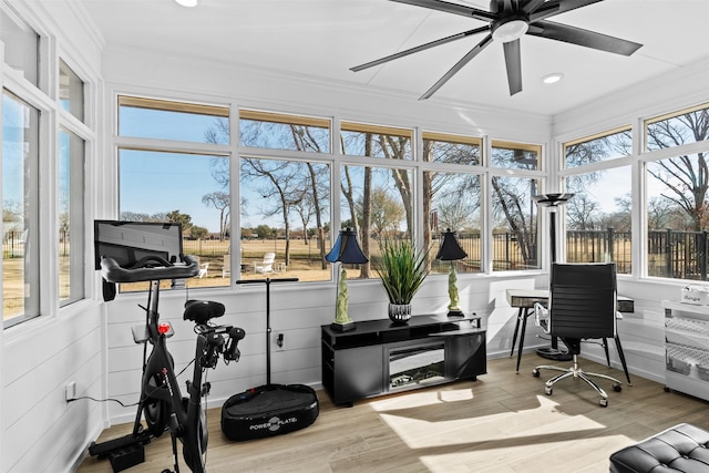 sunroom / solarium with ornamental molding, recessed lighting, and wood finished floors