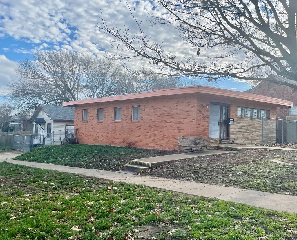 1317 Harrington Ave, Fort Worth, TX 76164 - view of property exterior with fence and brick siding