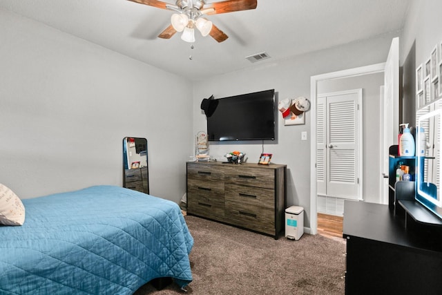 carpeted bedroom featuring visible vents and ceiling fan